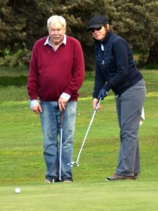 Louise receives some putting advice from Bill during the President's Day Ambrose event